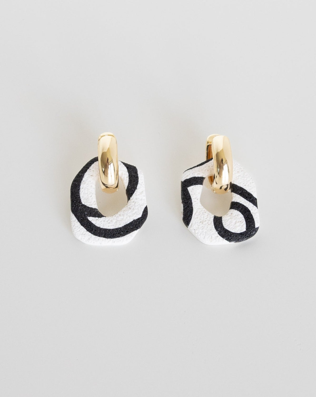 Darien earrings in Abstract White color with gold hoops, front view