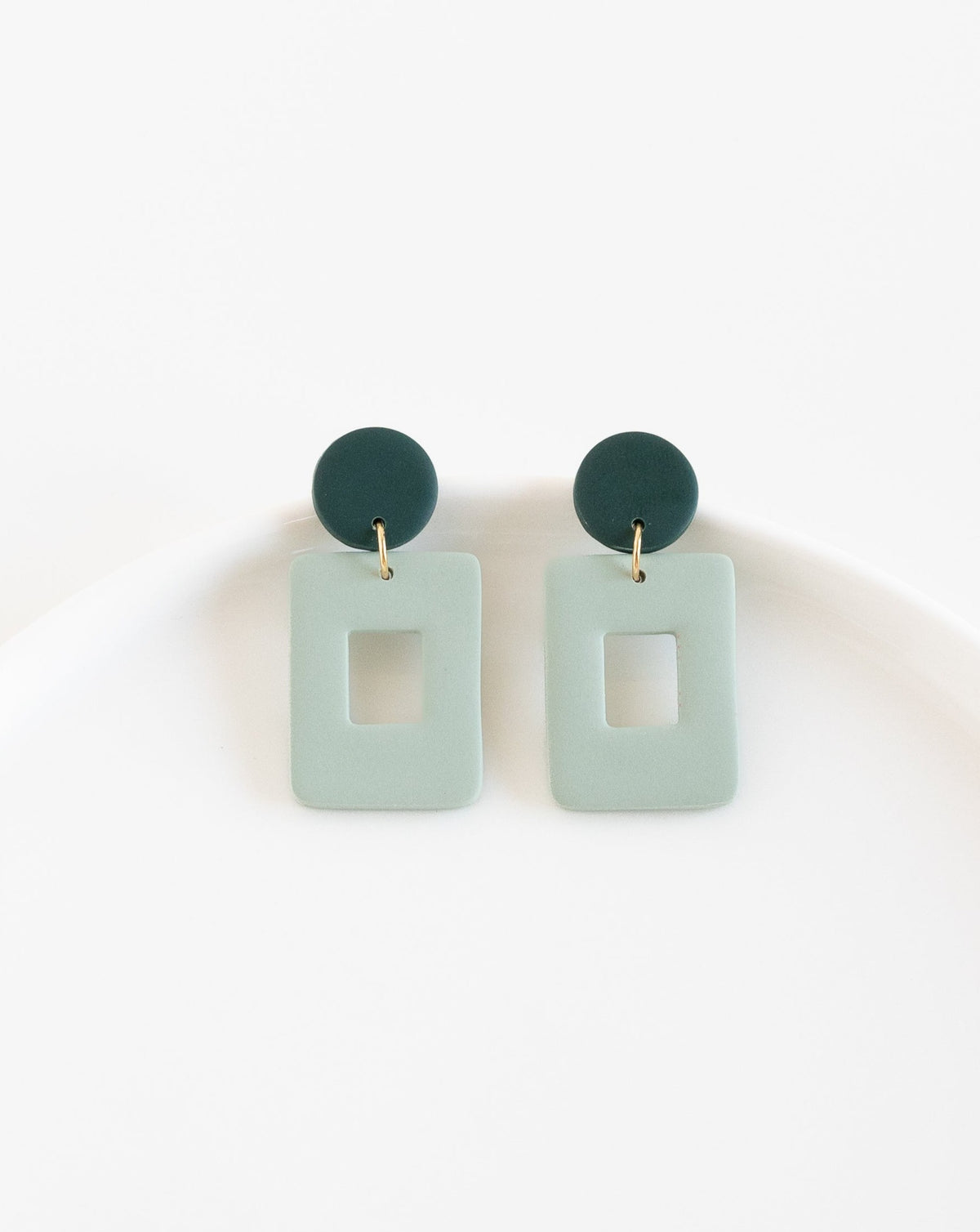 close-up of Muna earrings in sage color.