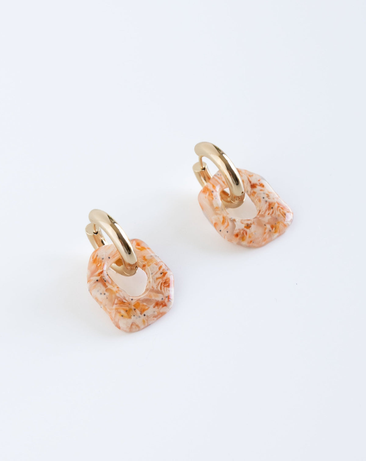 Darien earrings in Marble orange pattern with gold hoops, angled view