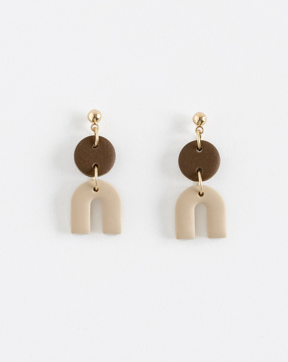Tiny Arch earrings in two part of brown and beige clay parts with gold plated Ball studs, front view.