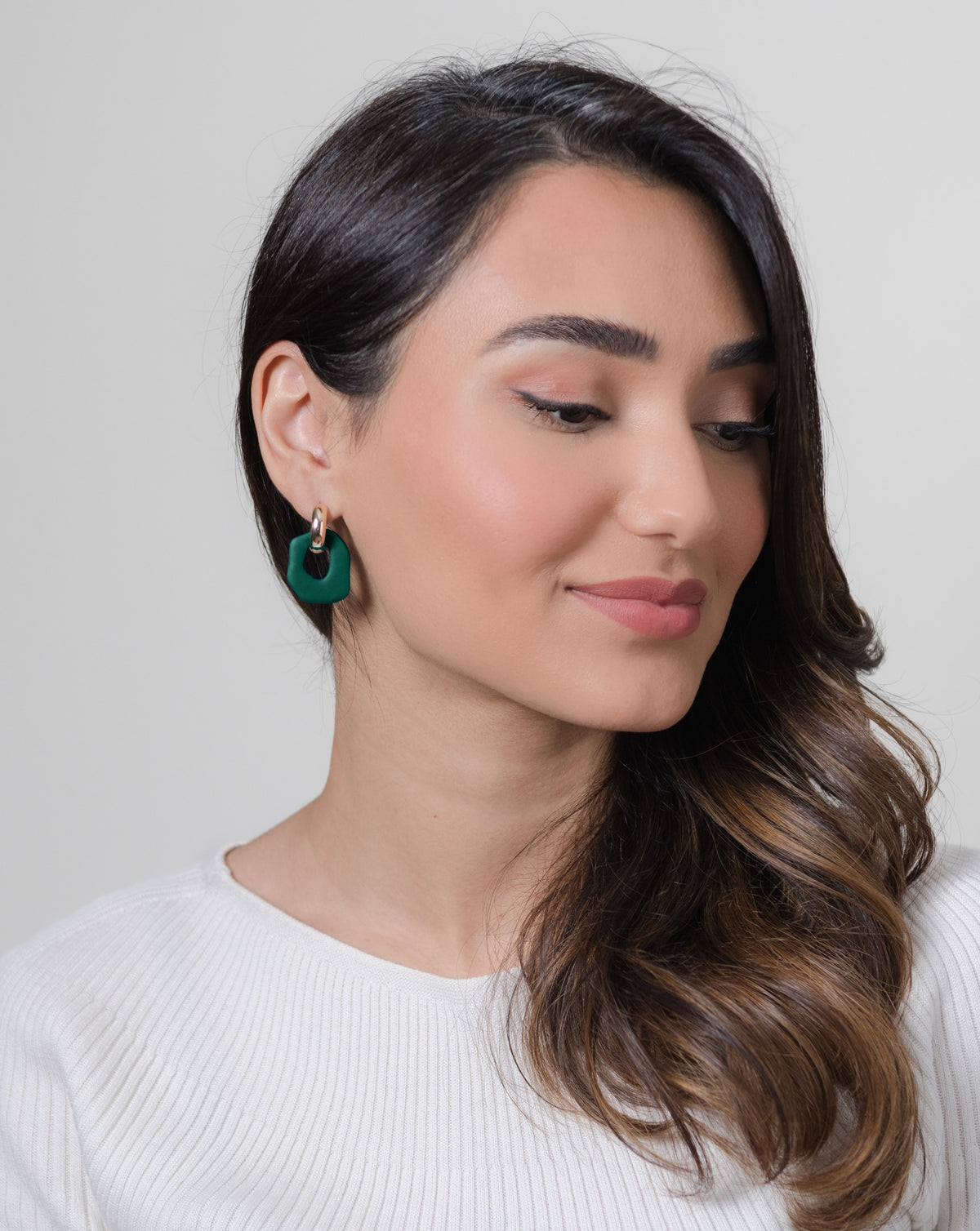 Darien earrings in Pine color with gold hoops, on model