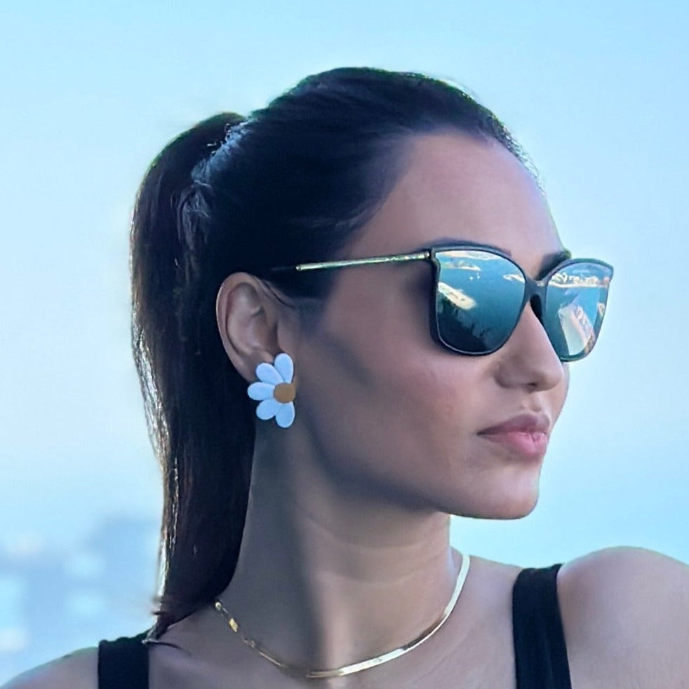 Daisy stud earrings on model.