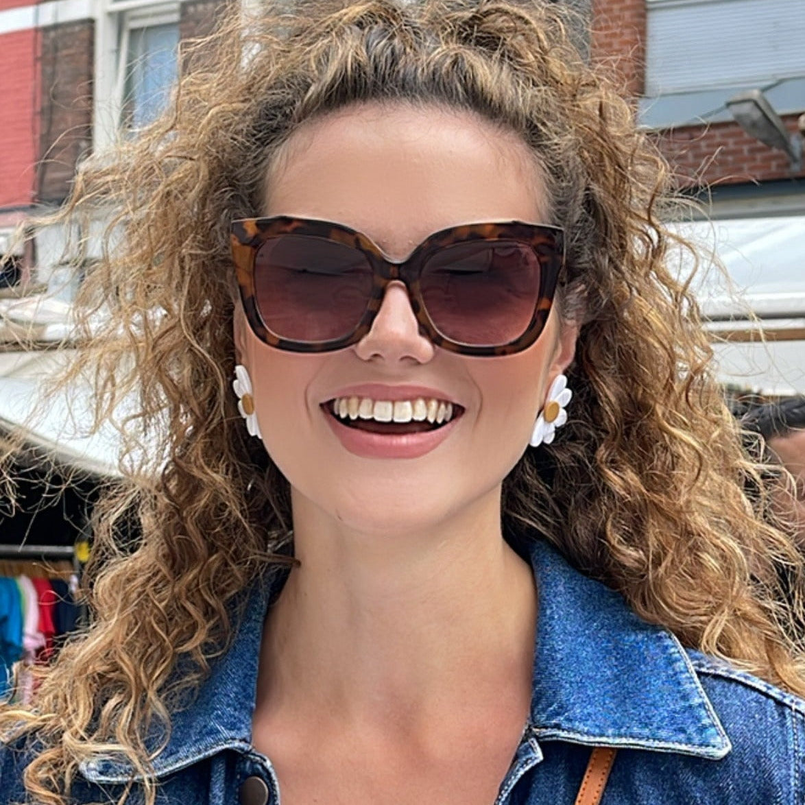 Daisy stud earrings on model