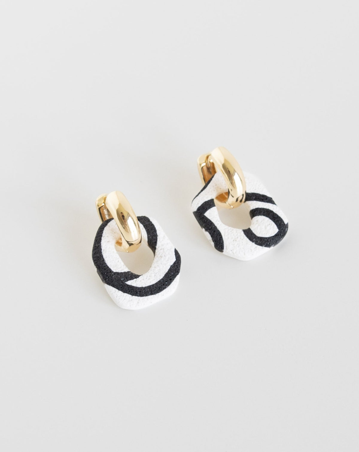 Darien earrings in Abstract White color with gold hoops, side view