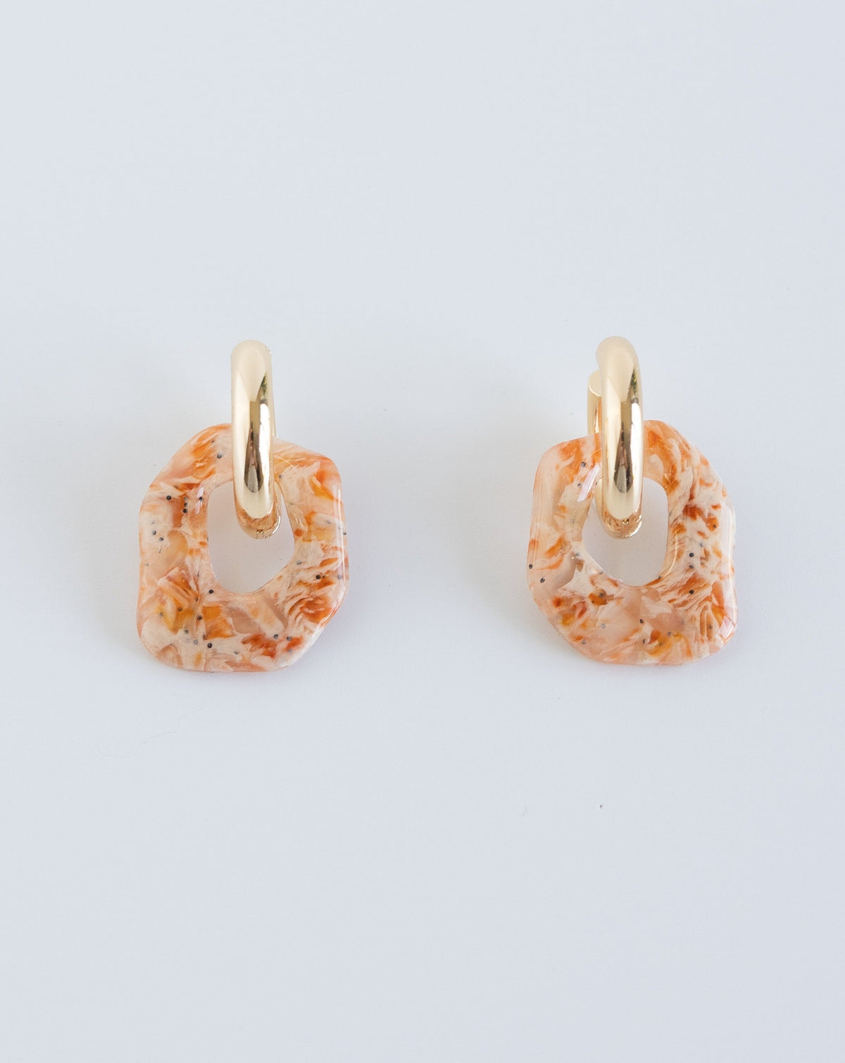 Darien earrings in Marble orange pattern with gold hoops, front view