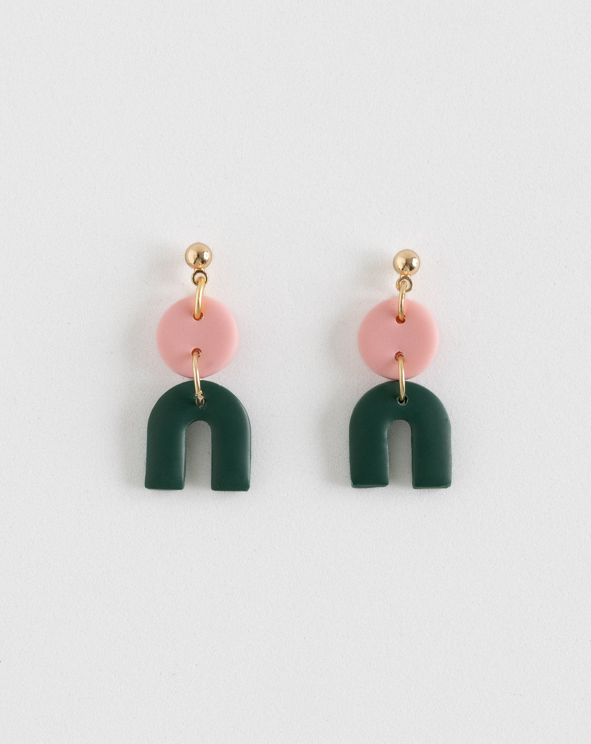 Tiny Arch earrings in two part of Sof pink and pine polymer clay parts with Gold plated Ball studs, front view.