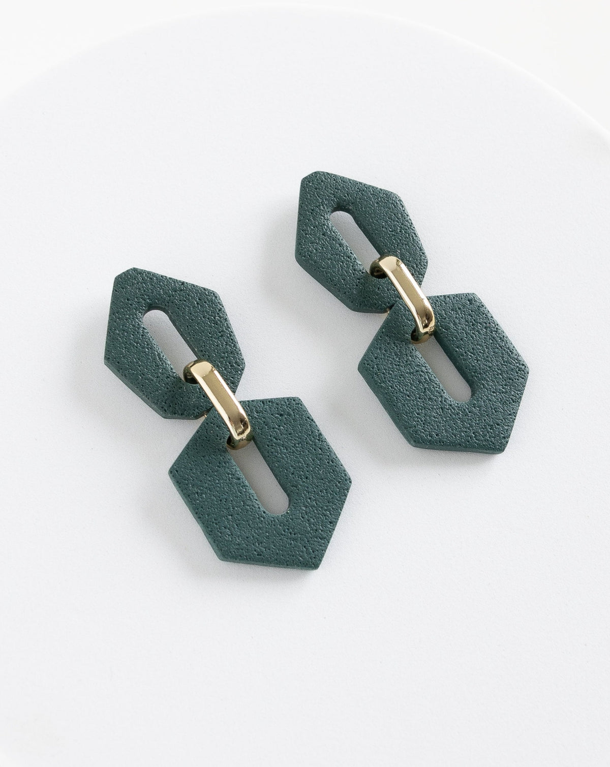 Angled view of Shilla earrings in Pine color.