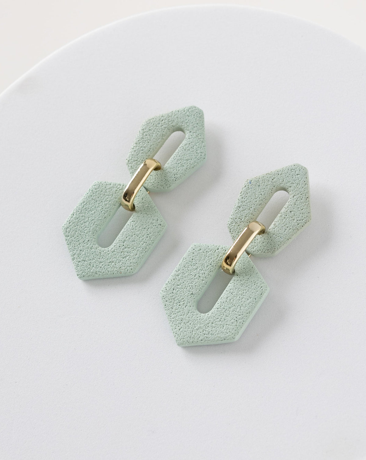 Close up of Shilla earrings in Sage color.