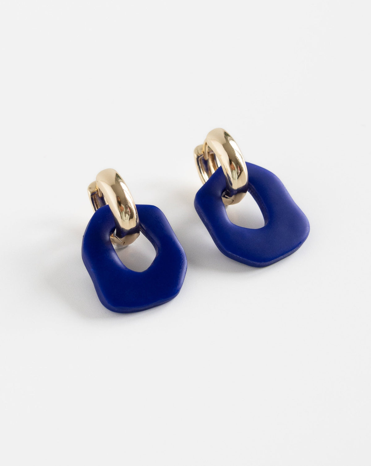 Close-up of Darien earrings in Hue blue with gold hoops