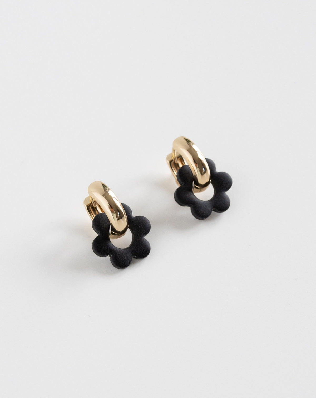 black color Goli Bold earrings in gold hoops