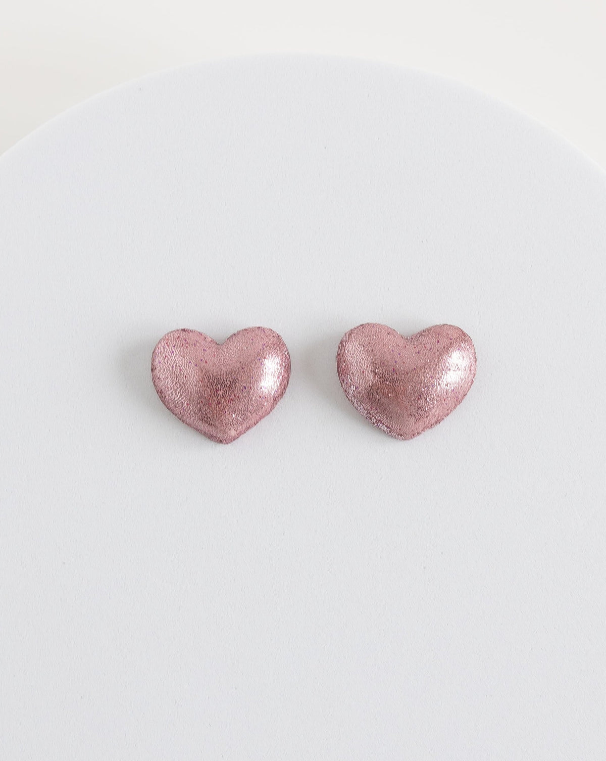 Pink heart stud earrings from LYHO, part of the collection supporting women victims of domestic violence..