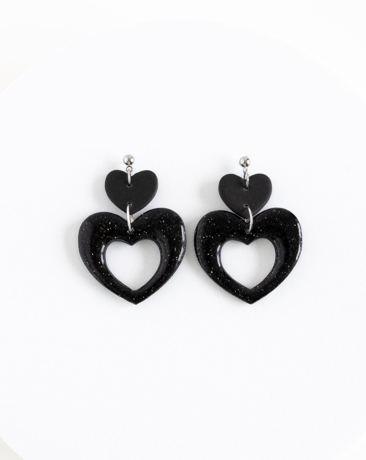 Close-up of my valentine earrings in color black with silver ball studs.