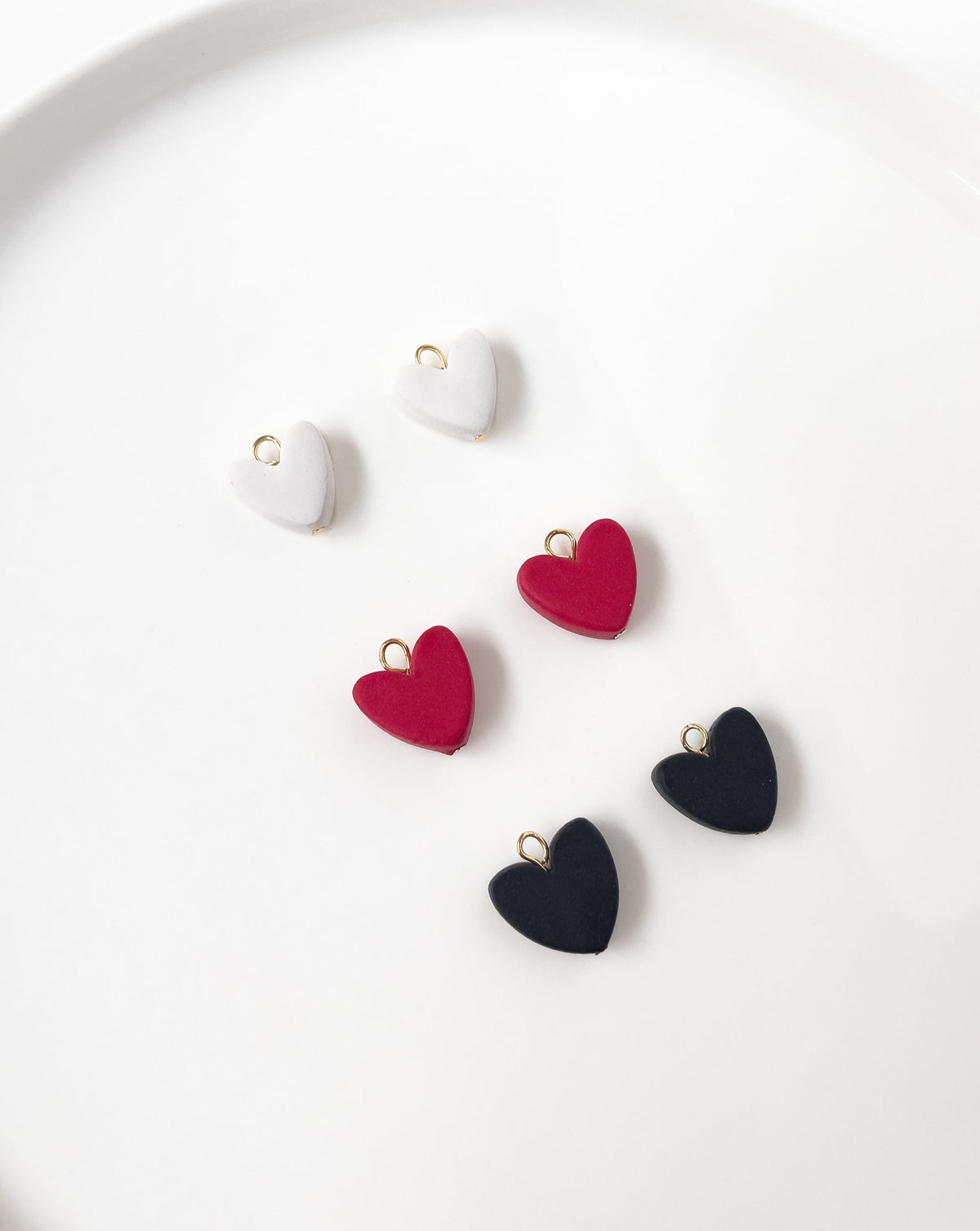 the collection of the heart charms in red,black and white colors.