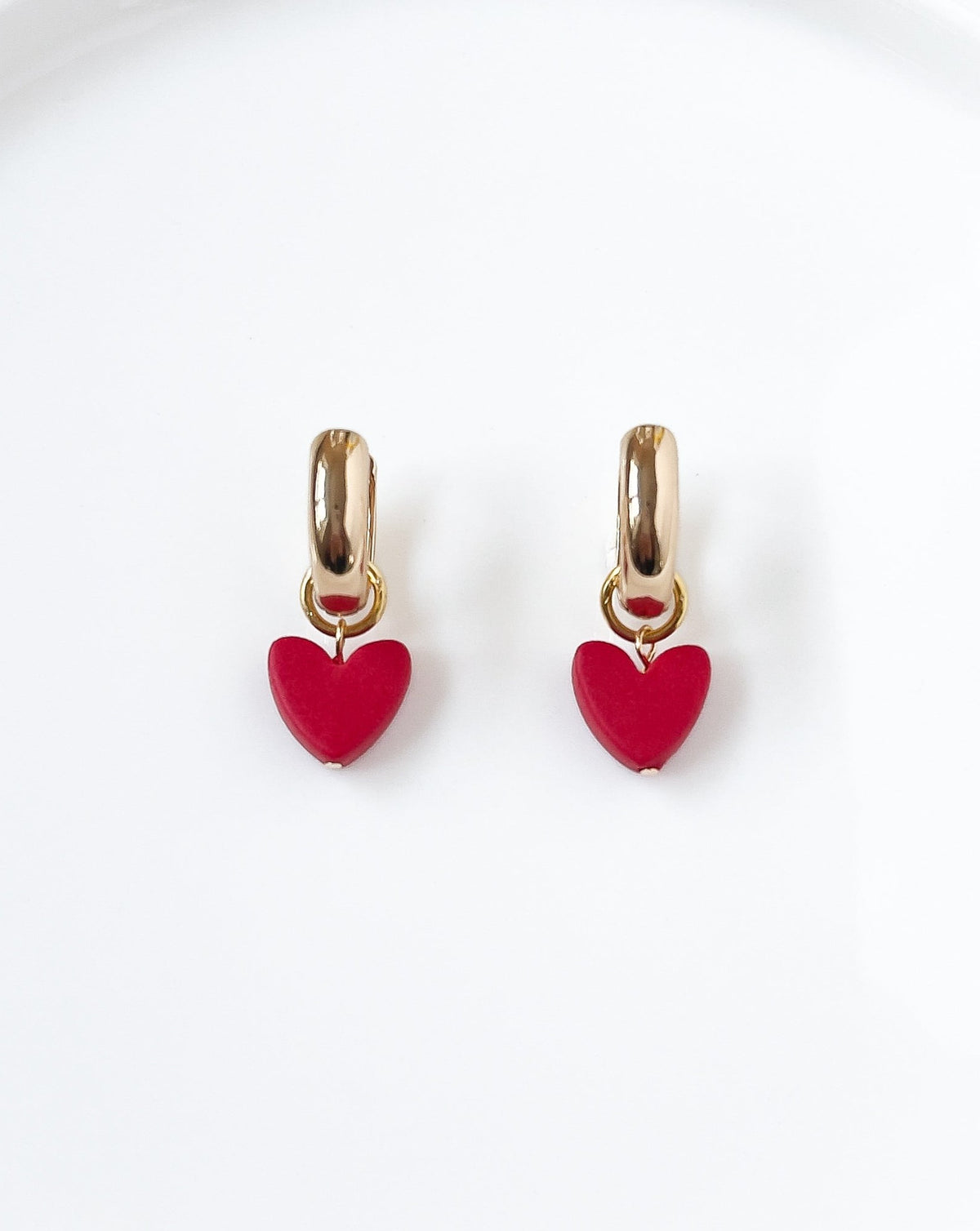 Showing the heart charm in color red with the Gold bold hoops.