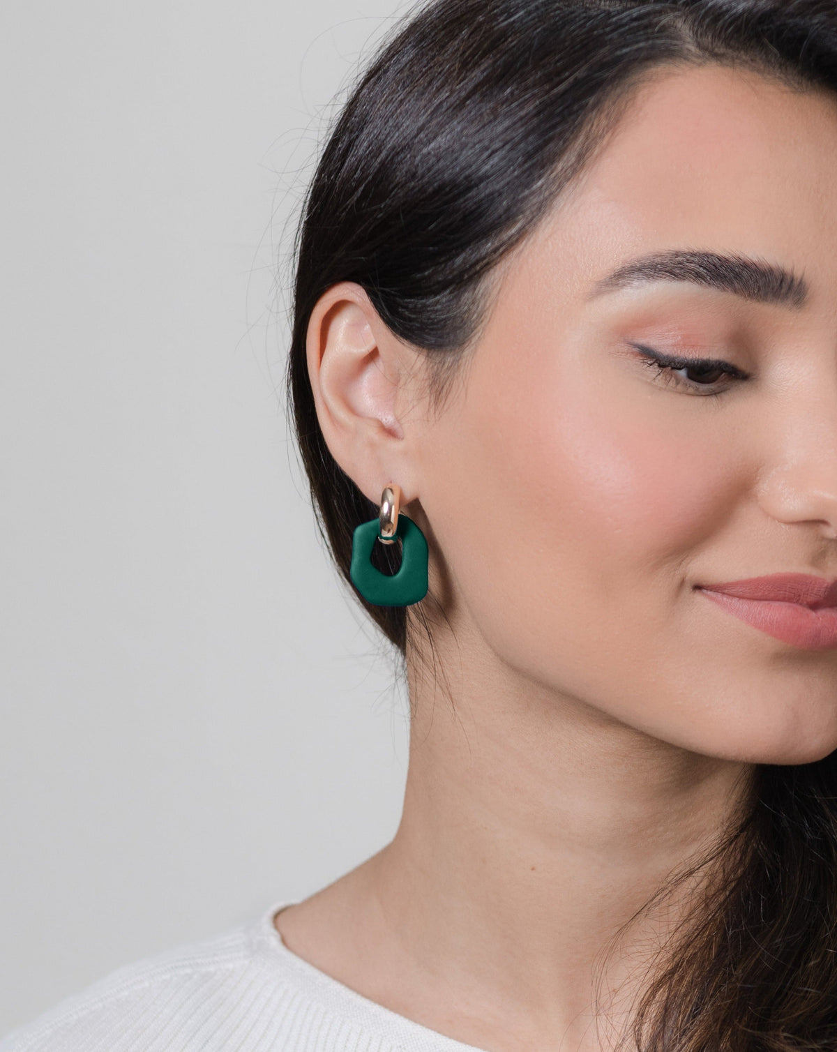 Daria earrings in Pine color with gold hoops, on model